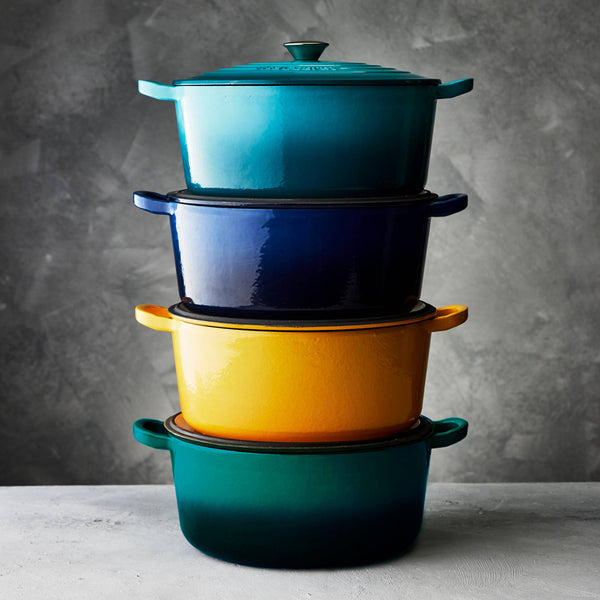 Cuisine::pro® LE CONNOISSEUR™ 6.6 Qt. Round French Oven stacked in vibrant colors.